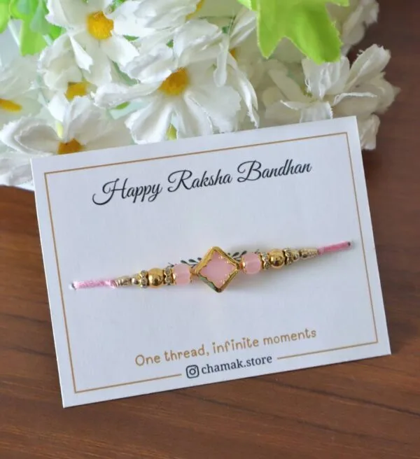 Soft Pink Stone Rakhi with Golden Accents